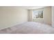 Bright carpeted bedroom with a large window and neutral paint providing an airy and relaxing retreat at 9960 Kline St, Broomfield, CO 80021