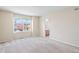Inviting carpeted bedroom with a view of a blooming tree from the large window at 9960 Kline St, Broomfield, CO 80021