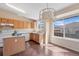 Eat-in kitchen features wood floors, a center island, and a window with views of the neighborhood at 9960 Kline St, Broomfield, CO 80021