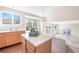 Spacious kitchen featuring an island with views of the living room and backyard at 9960 Kline St, Broomfield, CO 80021