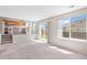 Open-concept living room with large windows and sliding glass door leading to backyard at 9960 Kline St, Broomfield, CO 80021