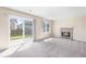 Cozy living room with a fireplace and sliding glass door leading to backyard at 9960 Kline St, Broomfield, CO 80021