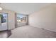 Inviting carpeted living room with large window offering neighborhood views at 9960 Kline St, Broomfield, CO 80021
