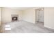 Spacious living room with a fireplace and neutral carpet, with a hall entry visible at 9960 Kline St, Broomfield, CO 80021