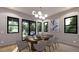 Dining room featuring modern light fixture, black framed windows, and wood dining table with seating for eight at 1227 N Ford St, Golden, CO 80403