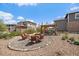 Landscaped backyard with a fire pit area, cozy seating, a covered patio, and lush surroundings at 26530 E Euclid Pl, Aurora, CO 80016