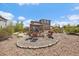 Backyard featuring a fire pit with seating, a covered pergola, and a beautifully landscaped area at 26530 E Euclid Pl, Aurora, CO 80016