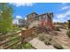 Charming home featuring a landscaped backyard, a wooden fence, and a mix of lush greenery and stone accents at 26530 E Euclid Pl, Aurora, CO 80016