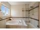 Well-lit bathroom featuring a separate shower and a luxurious soaking tub at 26530 E Euclid Pl, Aurora, CO 80016