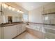Bright bathroom featuring double sinks, granite counters, and a glass-enclosed shower at 26530 E Euclid Pl, Aurora, CO 80016