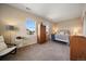 Bright bedroom with a neutral color scheme and a cozy sitting area at 26530 E Euclid Pl, Aurora, CO 80016