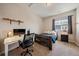 Bedroom with a modern desk, chair, and a comfortable bed at 26530 E Euclid Pl, Aurora, CO 80016