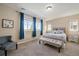 Comfortable bedroom featuring large windows, a cozy bed, and neutral decor at 26530 E Euclid Pl, Aurora, CO 80016