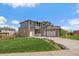 Charming two-story home featuring a well-manicured lawn and a three car garage at 26530 E Euclid Pl, Aurora, CO 80016