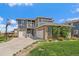 Two-story home with brick and siding and a three-car garage and basketball hoop at 26530 E Euclid Pl, Aurora, CO 80016
