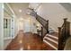 Bright foyer featuring hardwood floors and a staircase leading to the upper level at 26530 E Euclid Pl, Aurora, CO 80016