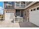 Inviting front porch with seating, leading to a three-car garage of this lovely home at 26530 E Euclid Pl, Aurora, CO 80016