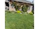 Beautiful home with lush green lawn and garden, featuring vibrant flowers and climbing vines at 26530 E Euclid Pl, Aurora, CO 80016