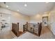 Second floor hallway with carpet, wood railing, and view of the downstairs area at 26530 E Euclid Pl, Aurora, CO 80016