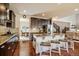 Kitchen featuring granite counters, a central island with seating, stainless steel appliances, and an adjacent dining area at 26530 E Euclid Pl, Aurora, CO 80016