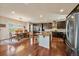 Modern kitchen features a large island, stainless steel appliances, and a dining area at 26530 E Euclid Pl, Aurora, CO 80016