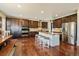 Spacious kitchen features dark wood cabinets, stainless steel appliances, and a large island with bar seating at 26530 E Euclid Pl, Aurora, CO 80016