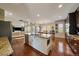 Open-concept kitchen with island, granite countertops, wood floors, adjacent to living and dining areas at 26530 E Euclid Pl, Aurora, CO 80016
