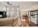 Open-concept living area with high ceilings, large windows and seamless kitchen access at 26530 E Euclid Pl, Aurora, CO 80016