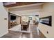 Inviting living room featuring a cozy fireplace, wood beams, rustic barn doors, and hardwood floors at 26530 E Euclid Pl, Aurora, CO 80016