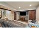 Comfortable living room with sliding barn doors, large TV, and cozy seating area at 26530 E Euclid Pl, Aurora, CO 80016