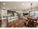 Open floor plan featuring the kitchen, dining, and living areas with a staircase and hardwood floors at 26530 E Euclid Pl, Aurora, CO 80016