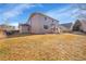 Backyard view; two story home; patio area with table and umbrella at 13457 Locust St, Thornton, CO 80602