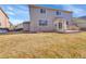 Well-maintained backyard featuring a concrete patio, manicured lawn, and partial fencing at 13457 Locust St, Thornton, CO 80602