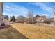 Flat backyard offering ample space with partial fencing and a concrete patio area at 13457 Locust St, Thornton, CO 80602