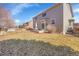 Large backyard with concrete patio for entertaining and lawn area; partially fenced at 13457 Locust St, Thornton, CO 80602