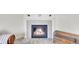 Inviting fireplace with stone surround and wood mantle, creating a warm focal point at 13457 Locust St, Thornton, CO 80602