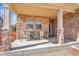 Inviting front porch with stone pillars and cozy seating arrangement at 13457 Locust St, Thornton, CO 80602