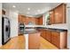 Spacious kitchen features granite countertops, stainless steel appliances, and wood cabinets at 13457 Locust St, Thornton, CO 80602