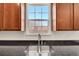 Close up on the kitchen sink with granite countertops and a window with a clear view to the outside at 13457 Locust St, Thornton, CO 80602