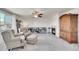 Open living room featuring a fireplace, plush armchairs, and a large window with window views at 13457 Locust St, Thornton, CO 80602