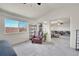 Open living room layout featuring a cozy chair and a large window with window views at 13457 Locust St, Thornton, CO 80602