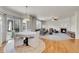 Open-concept living room with hardwood floors, fireplace, and large windows for natural light at 13457 Locust St, Thornton, CO 80602