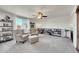 Bright living room with lots of natural light, plush seating, and a large window overlooking the backyard at 13457 Locust St, Thornton, CO 80602