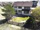 Aerial view of a well-maintained home featuring a beautiful backyard with mature trees, a grill, and outdoor seating at 10253 Fairgate Way, Highlands Ranch, CO 80126