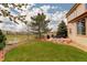 Expansive backyard with lush grass, a relaxing hammock, and an outdoor dining area, ideal for entertaining and leisure at 10253 Fairgate Way, Highlands Ranch, CO 80126