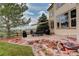 Beautiful backyard with a custom patio, outdoor dining set, and a charming rock water feature, perfect for entertaining at 10253 Fairgate Way, Highlands Ranch, CO 80126