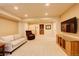 Finished basement featuring a cozy seating area with a large TV, offering an ideal space for relaxation at 10253 Fairgate Way, Highlands Ranch, CO 80126