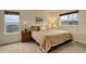 Comfortable bedroom featuring a queen-sized bed, large windows, and neutral decor, perfect for relaxation at 10253 Fairgate Way, Highlands Ranch, CO 80126
