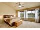 Spacious bedroom with large windows, ceiling fan, and neutral carpet flooring at 10253 Fairgate Way, Highlands Ranch, CO 80126