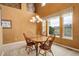 Cozy dining room with wood table, chandelier, and large windows for natural light at 10253 Fairgate Way, Highlands Ranch, CO 80126